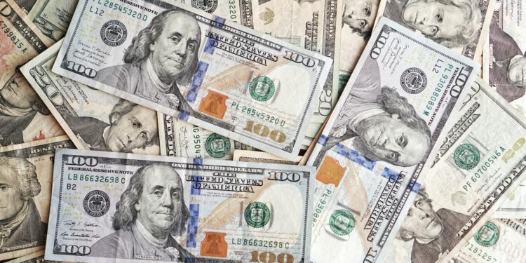 A Binance logo with a background of financial charts and US dollar bills, symbolizing regulation.