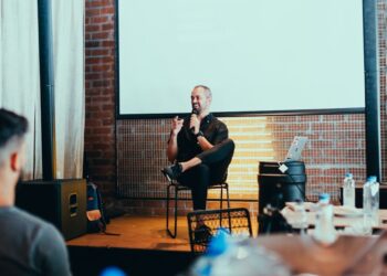 Candidates discussing cryptocurrency regulations at a debate stage during the Illinois Primary.