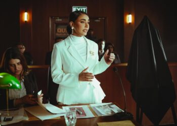 Prosecutors discussing legal documents in a courtroom related to Bankman-Fried's trial.