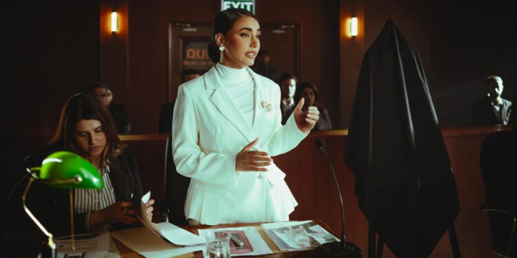 Prosecutors discussing legal documents in a courtroom related to Bankman-Fried's trial.