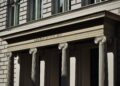 UK High Court building with Bitcoin logo overlay, symbolizing cryptocurrency legal status shift.