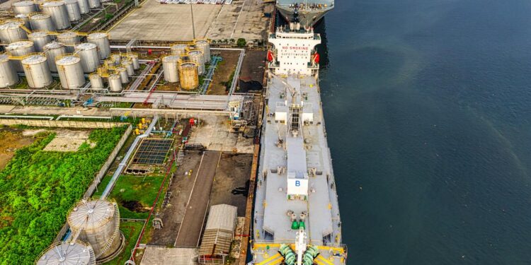 Cargo ships in a busy harbor, symbolizing oil trade and potential regulatory changes.