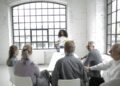 Group of business leaders discussing stablecoin regulations in a conference room setting.