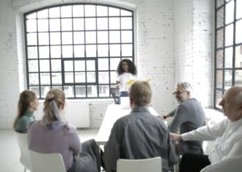Group of business leaders discussing stablecoin regulations in a conference room setting.