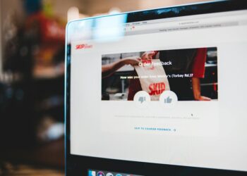 A person using a laptop with Grammarly's interface displayed, showing user feedback.