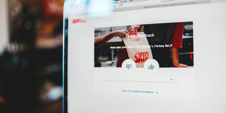 A person using a laptop with Grammarly's interface displayed, showing user feedback.