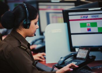 Law enforcement agents at a computer, disrupting a phishing operation linked to Tycoon 2FA.