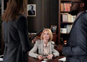 Microsoft and Anthropic executives discuss supply chain risks in a corporate meeting setting.