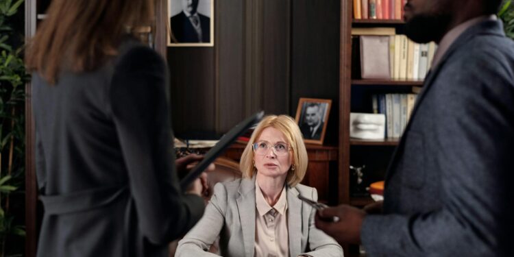 Microsoft and Anthropic executives discuss supply chain risks in a corporate meeting setting.