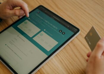A bank official demonstrates digital won on a tablet during a pilot program launch event.