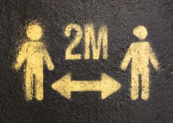 Two trading platforms logos with a warning sign, symbolizing insider trading prevention measures.