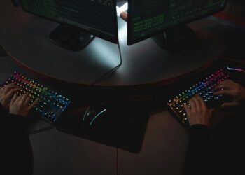 Swedish officials examining computer code on screens amid cybersecurity concerns.