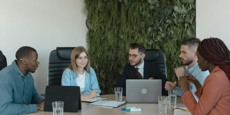 Banking professionals discuss cryptocurrency custody solutions at a conference table.
