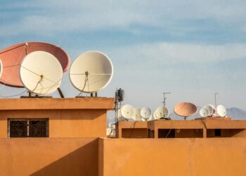 A Starlink satellite dish set against a night sky, symbolizing internet access during outages.
