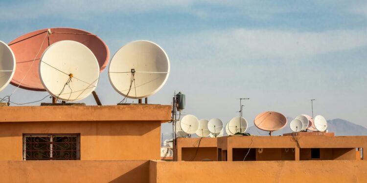 A Starlink satellite dish set against a night sky, symbolizing internet access during outages.