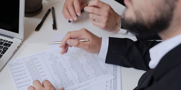 Regulatory officials discussing crypto rules at a conference table with documents and laptops.