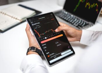 A financial advisor reviews cryptocurrency regulations on a digital tablet.