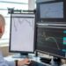 Traders monitor crypto charts on multiple screens with Binance logo in focus.