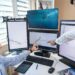 Traders analyzing cryptocurrency charts on multiple screens with finance data displayed.
