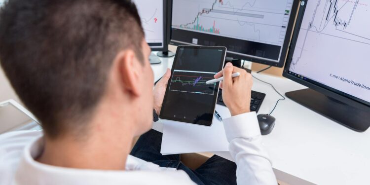 A financial analyst reviewing charts on a digital display related to crypto profits.