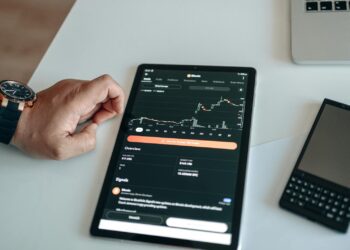 Traders analyzing cryptocurrency market trends on digital screens with Bitcoin graphics.