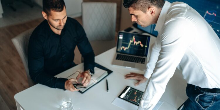A trader reviews cryptocurrency graphs with a worried expression and Aave logo in the background.