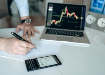 Changpeng Zhao speaking at a conference, surrounded by cryptocurrency graphics and charts.