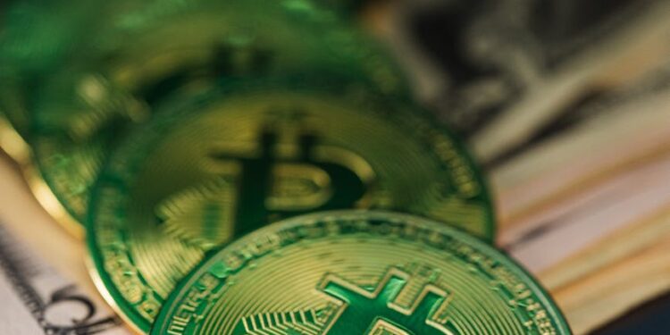 Stack of dollar bills next to a digital crypto coin, symbolizing financial fraud.