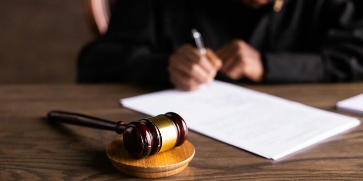 Federal judge deliberating at a legal desk with documents about Pentagon regulations.