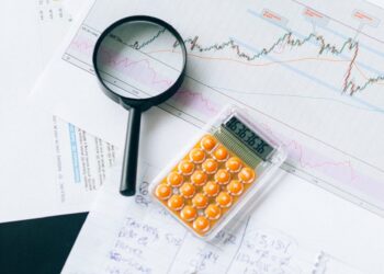 Institutional investors examining Staked Ethereum ETF financial documents and charts.