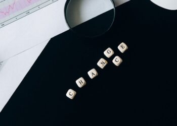 An investor examines cryptocurrency charts with legal documents on a desk.