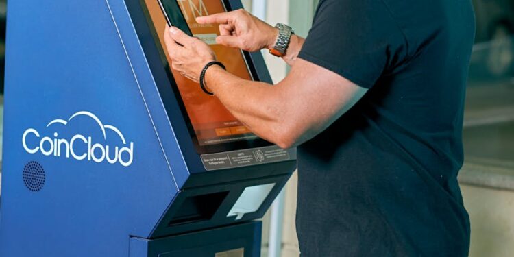 A person using a crypto ATM in a busy urban environment, surrounded by warning signs.