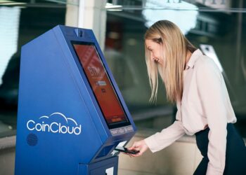 Bitcoin ATM machine with regulatory warning sign in a Connecticut setting.