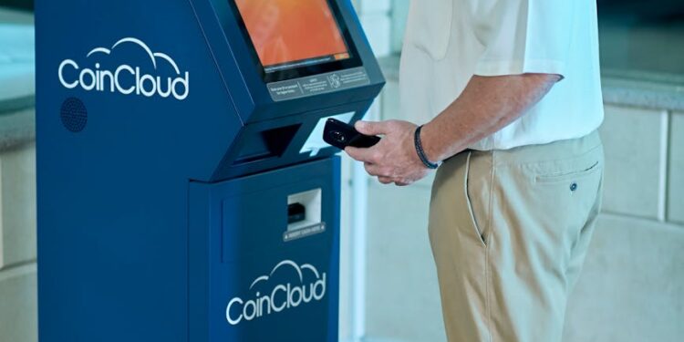 Individuals reviewing cryptocurrency transactions on a computer screen, highlighting financial regulation.