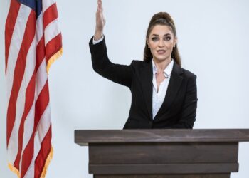 A politician gestures while announcing a ban on crypto donations to political parties.