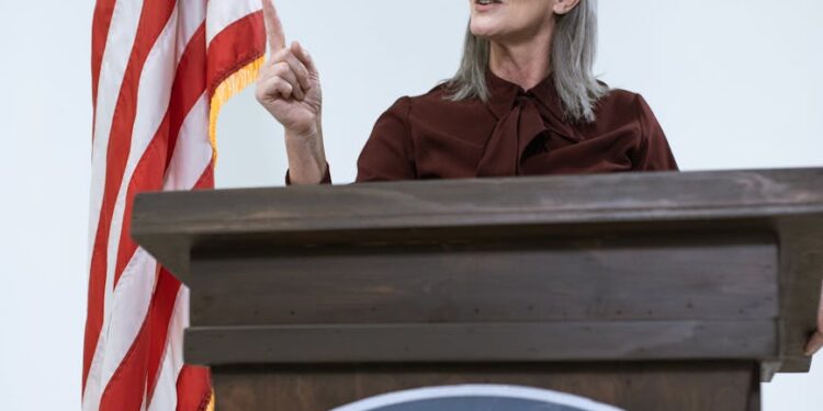 Dario Amodei speaking at a podium, discussing AI regulations and Pentagon policies.