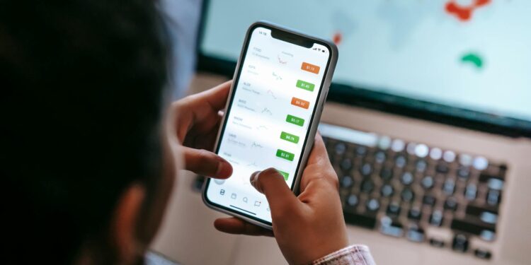 Traders analyze stock trends on digital screens in a busy finance office.