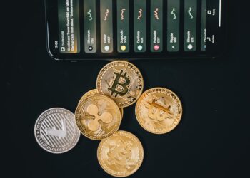 A smartphone displaying a Bitcoin wallet with the New York skyline in the background.