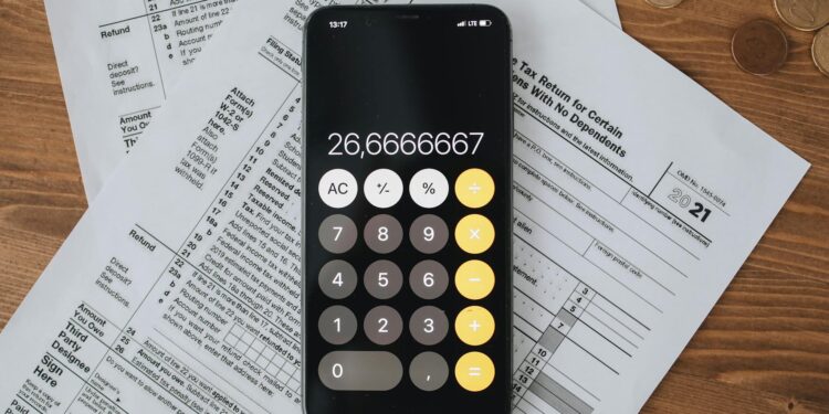 A person reviews digital cryptocurrency tax forms on a laptop screen.