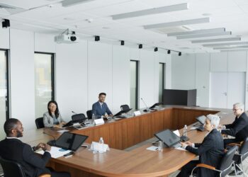 Trump sits at a conference table with Meta and Nvidia CEOs during a council meeting.