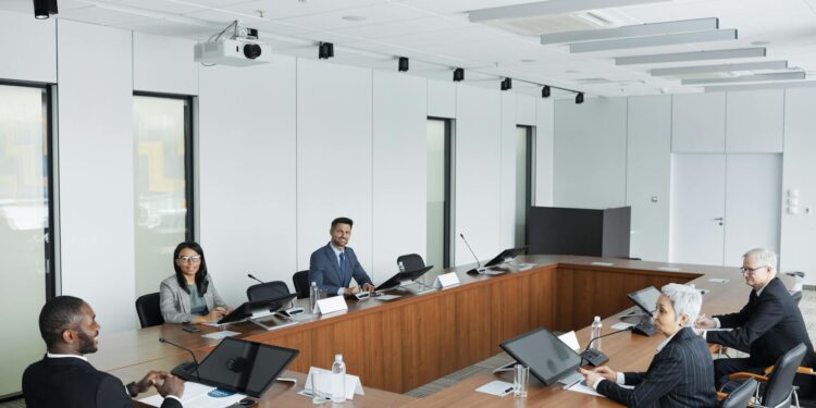 Trump sits at a conference table with Meta and Nvidia CEOs during a council meeting.