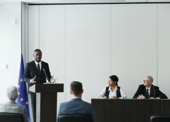 Senator at podium discussing bipartisan legislation for cryptocurrency regulation.