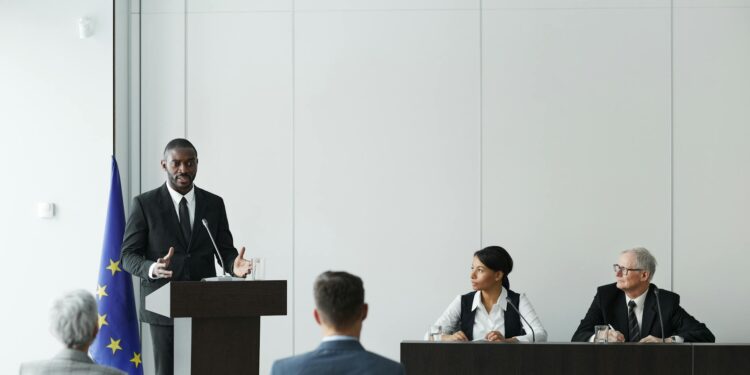 Senator at podium discussing bipartisan legislation for cryptocurrency regulation.