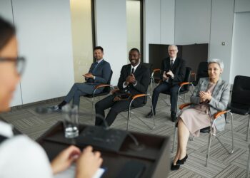 Group of experts discussing cryptocurrency regulations at a conference.