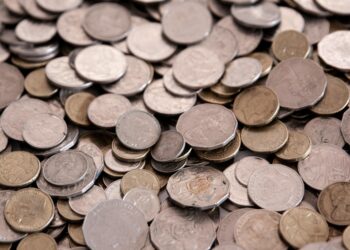 Ripple logo overlaying an Australian map with currency symbols representing financial transactions.