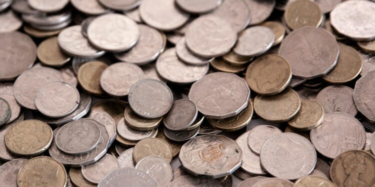 Ripple logo overlaying an Australian map with currency symbols representing financial transactions.