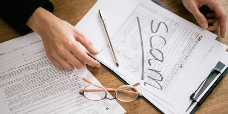 A financial advisor reviews stablecoin regulations with crypto documents and a calculator.