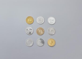 Bitcoin coins arranged on a table with a digital wallet interface displayed in the background.