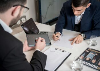 Business meeting with advisors discussing cryptocurrency and AI policy regulations.