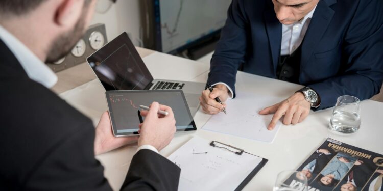 Business professionals discussing cryptocurrency strategy in a modern office setting.